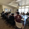 A LiFT workshop in the Navaho Nation in Arizona. About a dozen people are shown around a conference table in a light-filled room with big windows.
