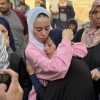 A Palestinian mother is embraced by another woman as mourns her son, who was killed in an Israeli airstrike just over a month into the ceasefire, at Al-Shifa Hospital, in Gaza City, on November 20, 2025.
