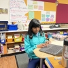 Fifth-grader Ameya Desai works at a research project that she's presenting to her class at Williams Elementary School in San Jose, Calif.