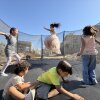 Palestinian children leap into the air while playing on a trampoline in northern Gaza's militarized orange zone of Beit Lahia, on May 31.