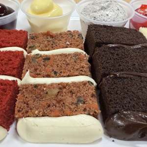 A flight of wedding cake samples at a Publix in Vestavia Hills, Alabama on September 23, 2026. Cake flavors from left to right are red velvet, carrot cake, chocolate and vanilla. Filling flavors from left to right are raspberry; vanilla custard; cookies and cream mouse; and strawberry.