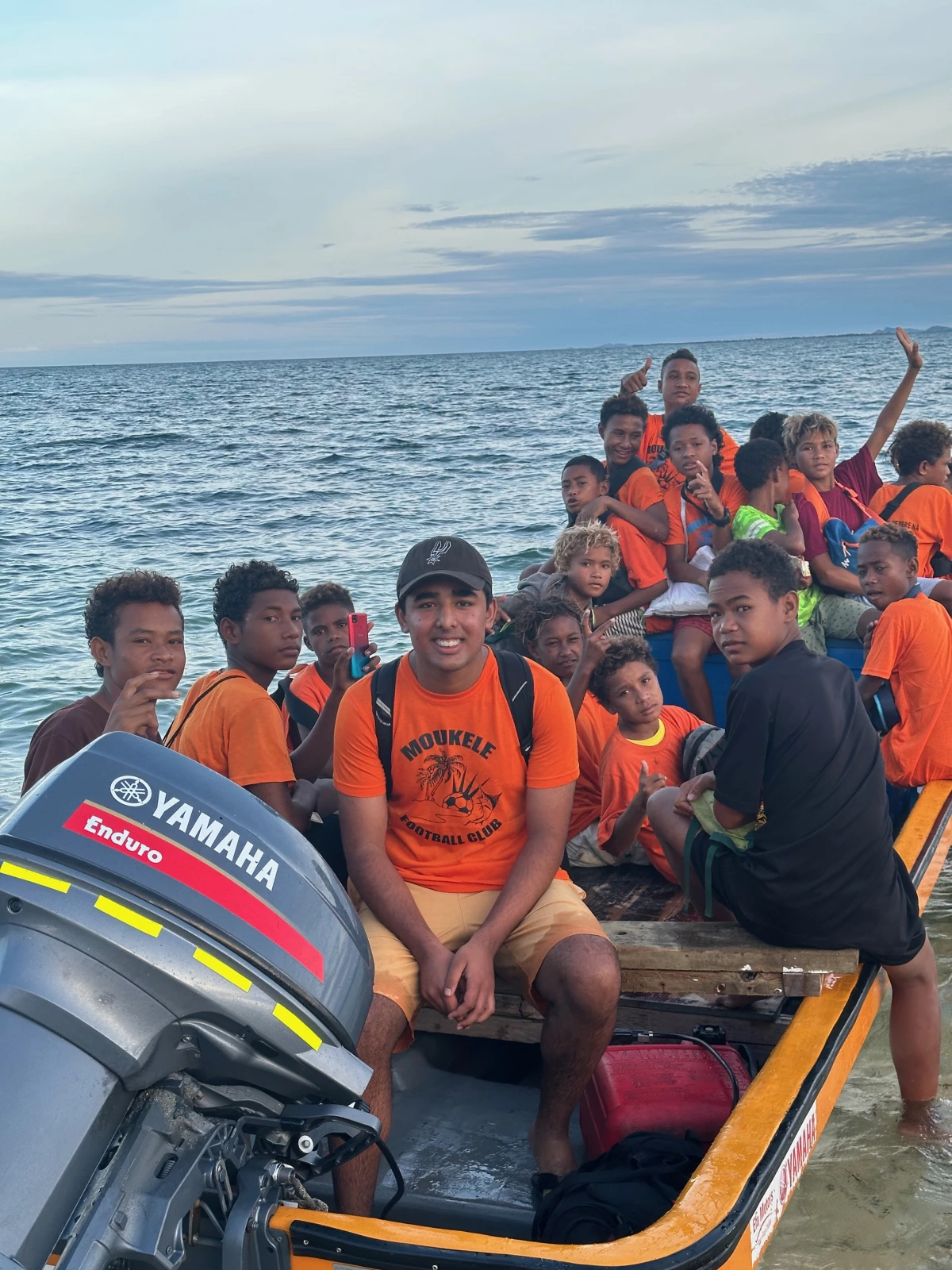 Arjun Malaviya on a boat ride with local children in Papua New Guinea.