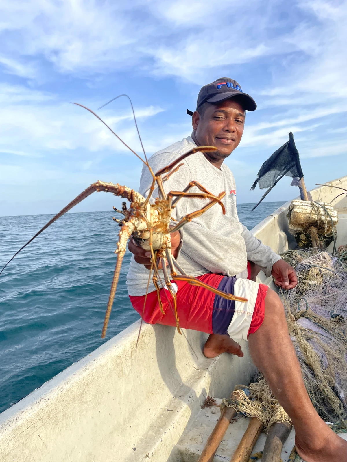 Euris Cervantes, a Colombian fisherman, displays one of his day's catch — a lobster — caught in the Caribbean waters near Punta Canoa.