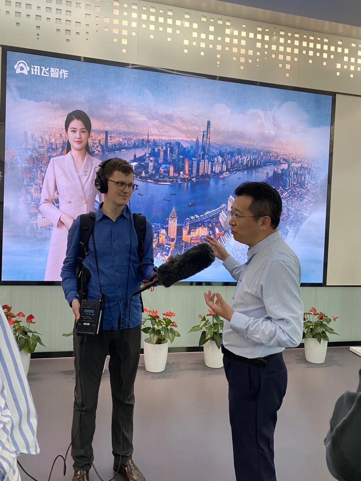 NPR producer Taylor Haney and iFlyTek's CFO Duan Dawei talking about the company's AI generated software, Shanghai, China on April 27, 2024.