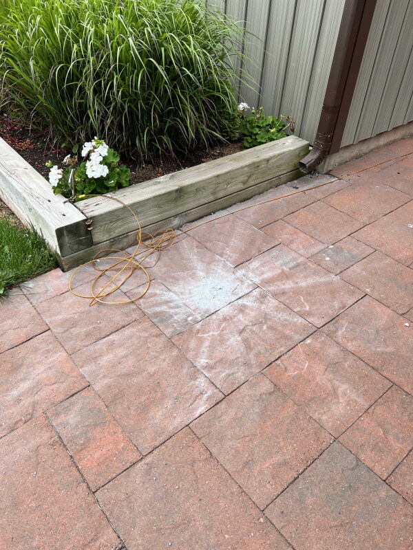 Dust in the shape of a starburst from a meteorite on a red brick walkway at a home on Prince Edward Island, Canada.