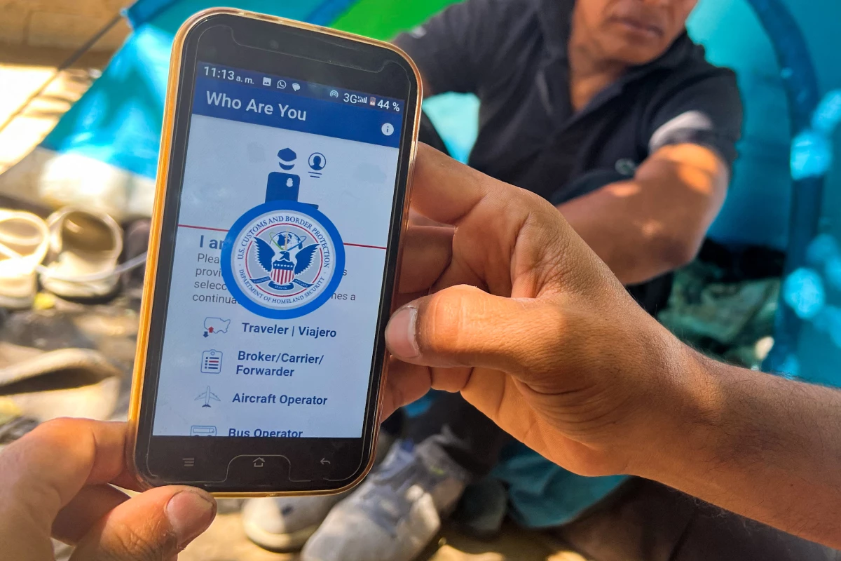 A migrant at the U.S.-Mexico border shows the CBP One App from the U.S. Customs and Border Protection agency that is used to apply for an appointment to apply for asylum.