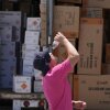 Wyatt Seymore pours the last drops of liquid from a water bottle into his mouth on June 17 as he takes a break from unloading a stiflingly hot trailer of fireworks outside Powder Monkey Fireworks ahead of the opening of the stand in Weldon Spring, Mo.