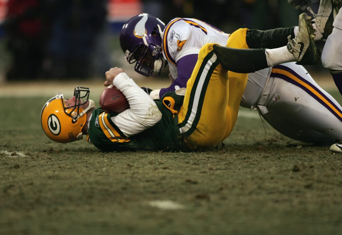 Brett Favre #4 of the Green Bay Packers is tackled by a Minnesota Vikings defensive player during the NFC wild-card game at Lambeau Field on January 9, 2005 in Green Bay, Wisconsin. Favre said Tuesday he's battling Parkinson's disease which comes after a 20-year all-star NFL career where he had numerous concussions.