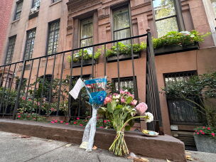 Flowers rest outside of Gloria Steinem's Manhattan apartment on Thursday.