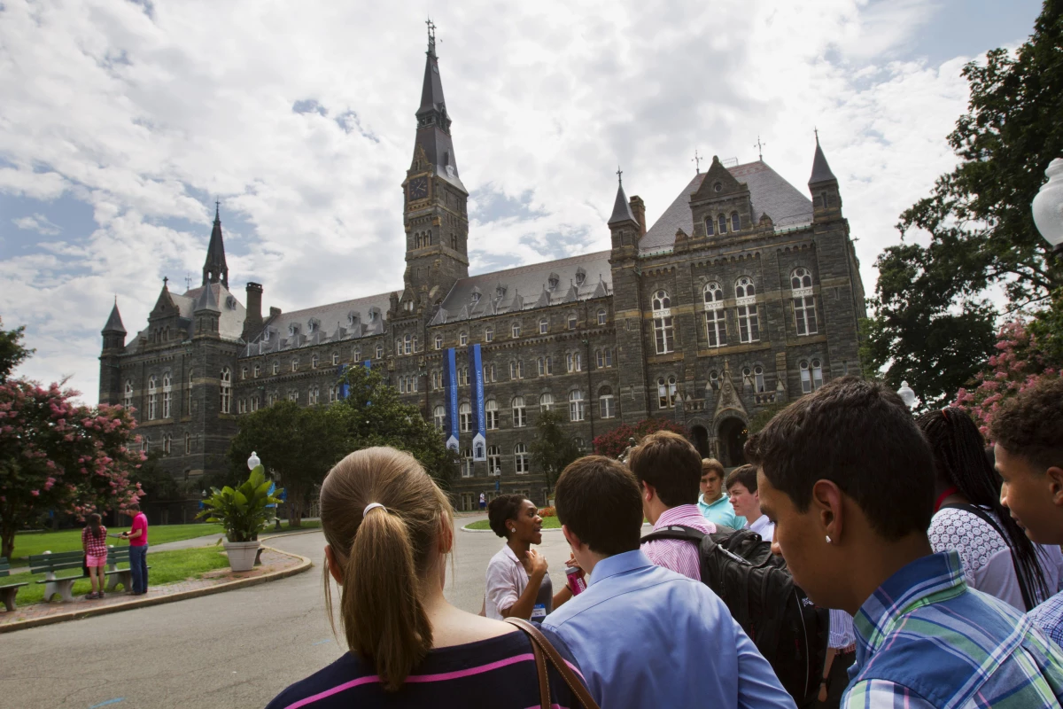 In this July 10, 2013, file photo, prospective students tour Georgetown University's campus in Washington.  (AP Photo/Jacquelyn Martin, File)