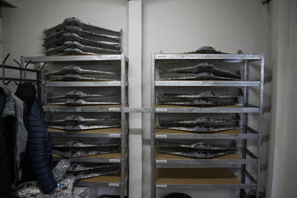 Completed drone bodies rest on shelves in the back of the workroom at Skyassist in Ukraine.