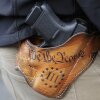 An attendee at a gun rights rally open-carries his gun in a holster that reads "We the People," from the Preamble to the U.S. Constitution, in this 2019 photo at the Capitol in Olympia, Wash.