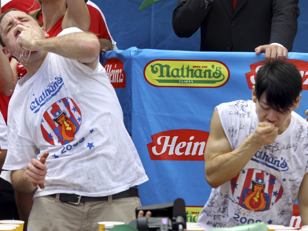 Joey Chestnut (L) and Takeru Kobayashi (R) compete in the Nathan's hot dog-eating contest on July 4, 2009, in New York.  (AP)