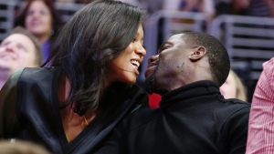 Kiss cams often capture moments of delight, such as this 2014 smooch between comedian Kevin Hart and fiancee Eniko Parrish at an NBA basketball game between the Golden State Warriors and Los Angeles Clippers in Los Angeles. But as this week's incident involving a tech CEO and his human resources head shows, kiss cam footage can cause