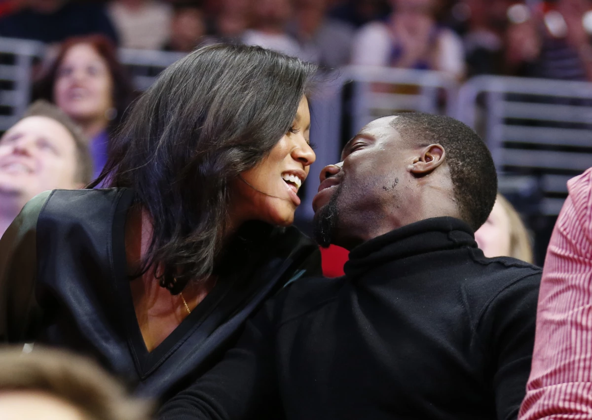 Kiss cams often capture moments of delight, such as this 2014 smooch between comedian Kevin Hart and fiancee Eniko Parrish at an NBA basketball game between the Golden State Warriors and Los Angeles Clippers in Los Angeles. But as this week's incident involving a tech CEO and his human resources head shows, kiss cam footage can cause trouble.