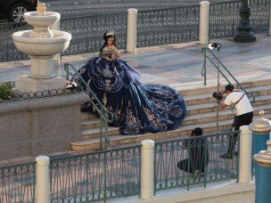 Outside the Venetian in Las Vegas, people take photos for special events because of the architecture that mimics the canals and plazas of Venice, Italy.