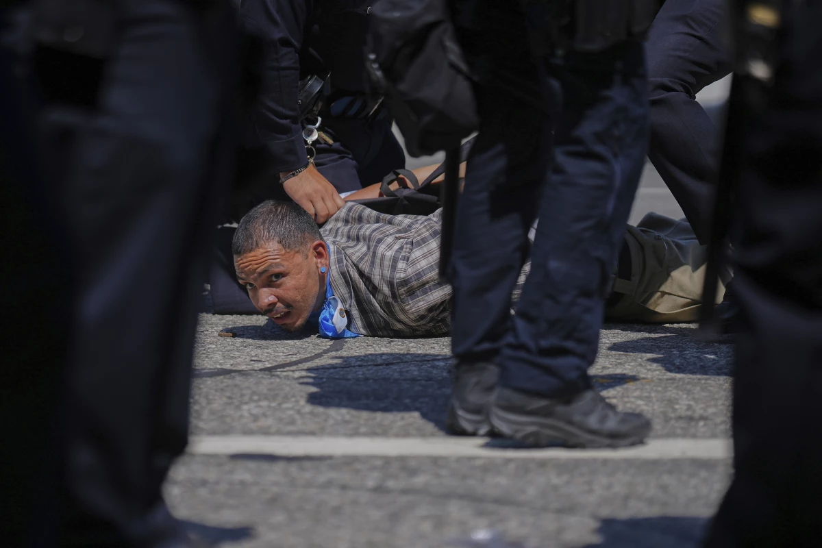 A protester is detained by police in downtown Los Angeles.