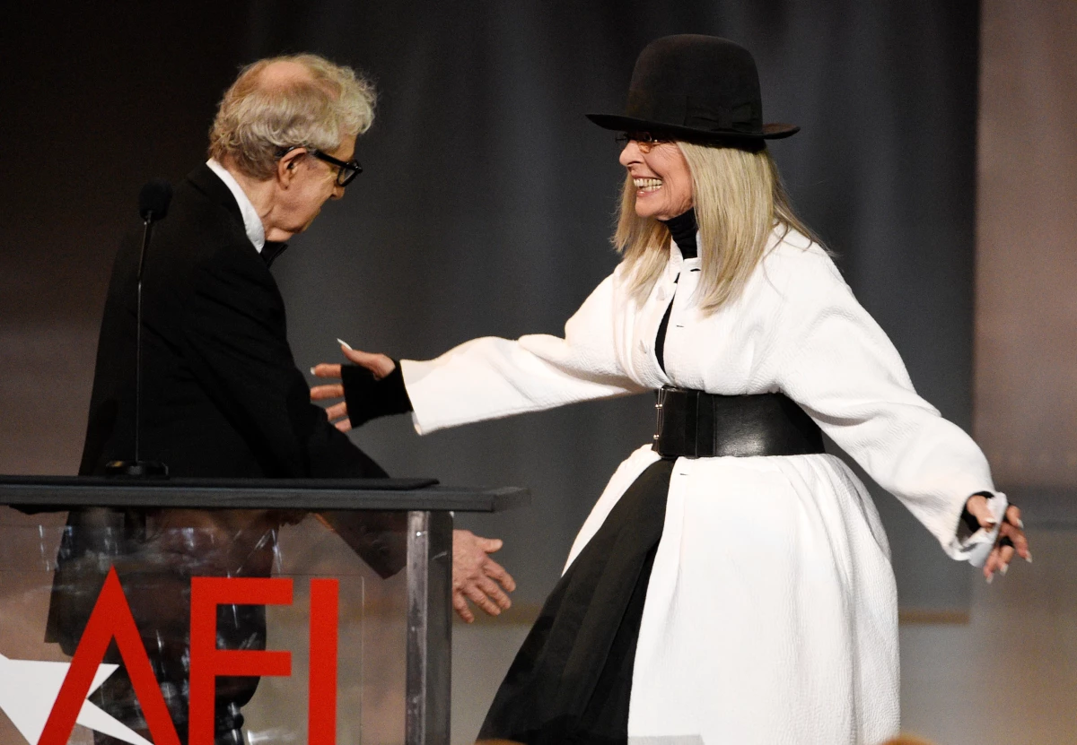 FILE - Filmmaker Woody Allen, left, greets actress Diane Keaton onstage to present her with the 45th AFI Life Achievement Award on June 8, 2017, in Los Angeles.