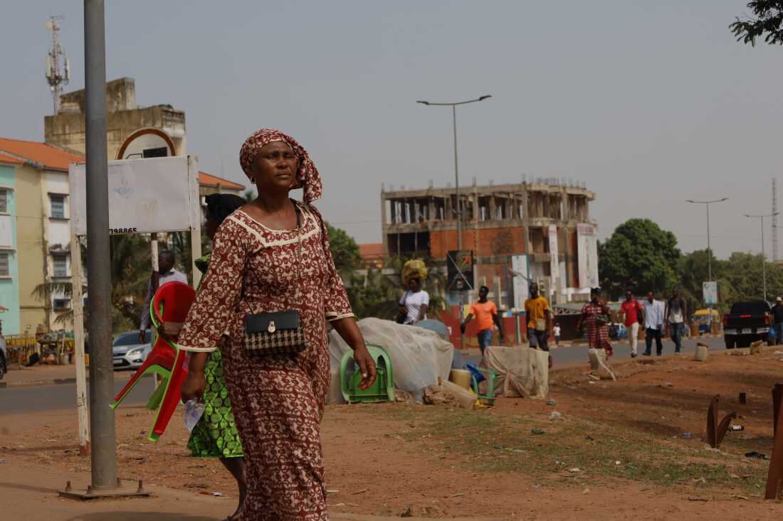 People walk on the street in Bissau, Guinea-Bissau, Wednesday.