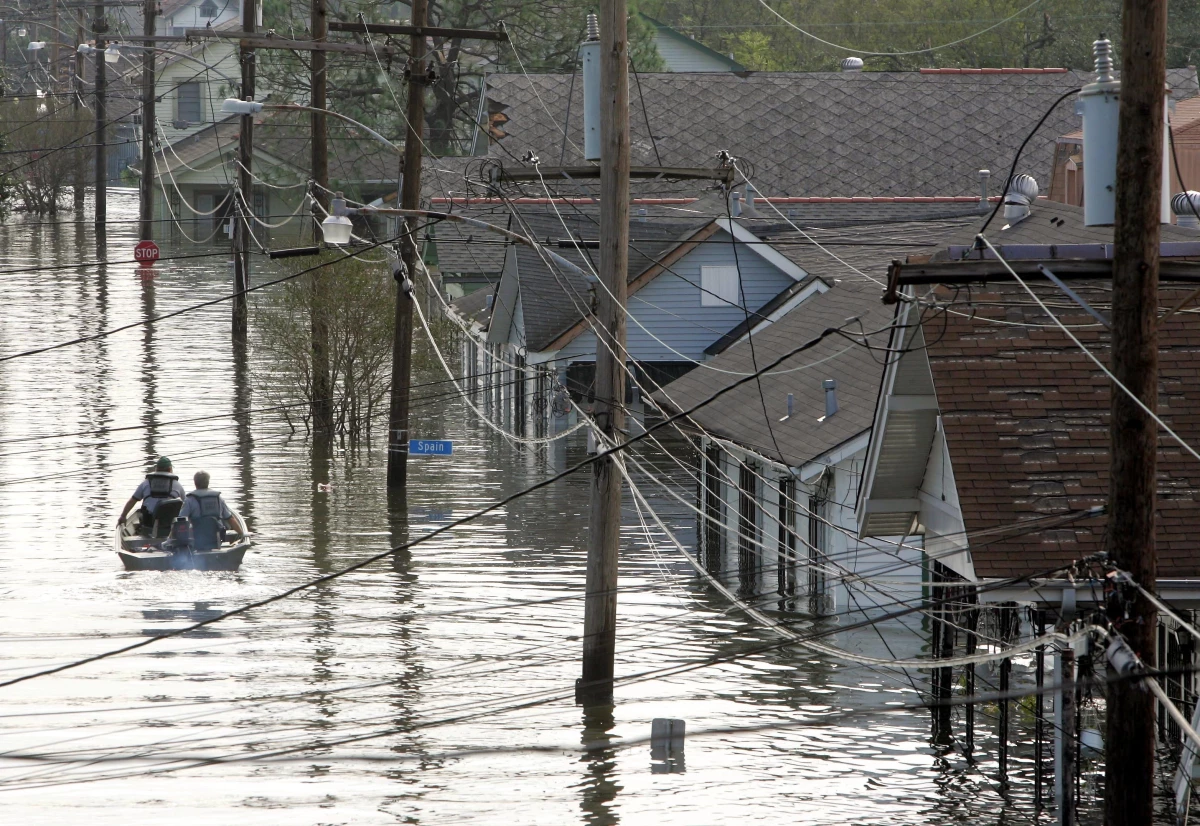 In this Aug. 30, 2005 file photo, rescue personnel search from victims as they traverse the New Orleans 8th Ward in the flooded city of New Orleans.