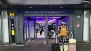 Travellers arrive at Terminal 5 as Heathrow Airport slowly resumes flights after a fire cut power to Europe's busiest airport in London, on Saturday.