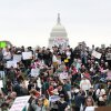 Protesters attend a "Hands Off" rally Saturday to demonstrate against President Trump on the National Mall in Washington, D.C.