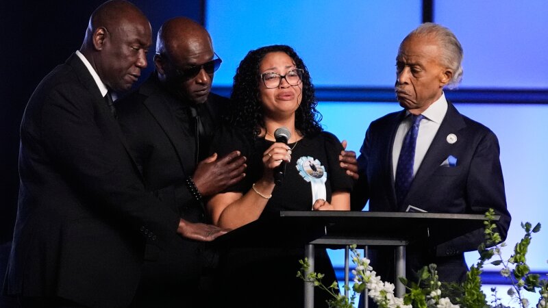 Christine Wells-Wonsley (center) is flanked by her husband, Elmore (second from left), attorney Ben Crump (left), and the Rev, Al Sharpton (right) during a memorial service on Monday in Ocean Springs, Miss., for her son Nolan Xavier Wells, an 18-year-old found dead after taking a July 4 boat trip with friends.