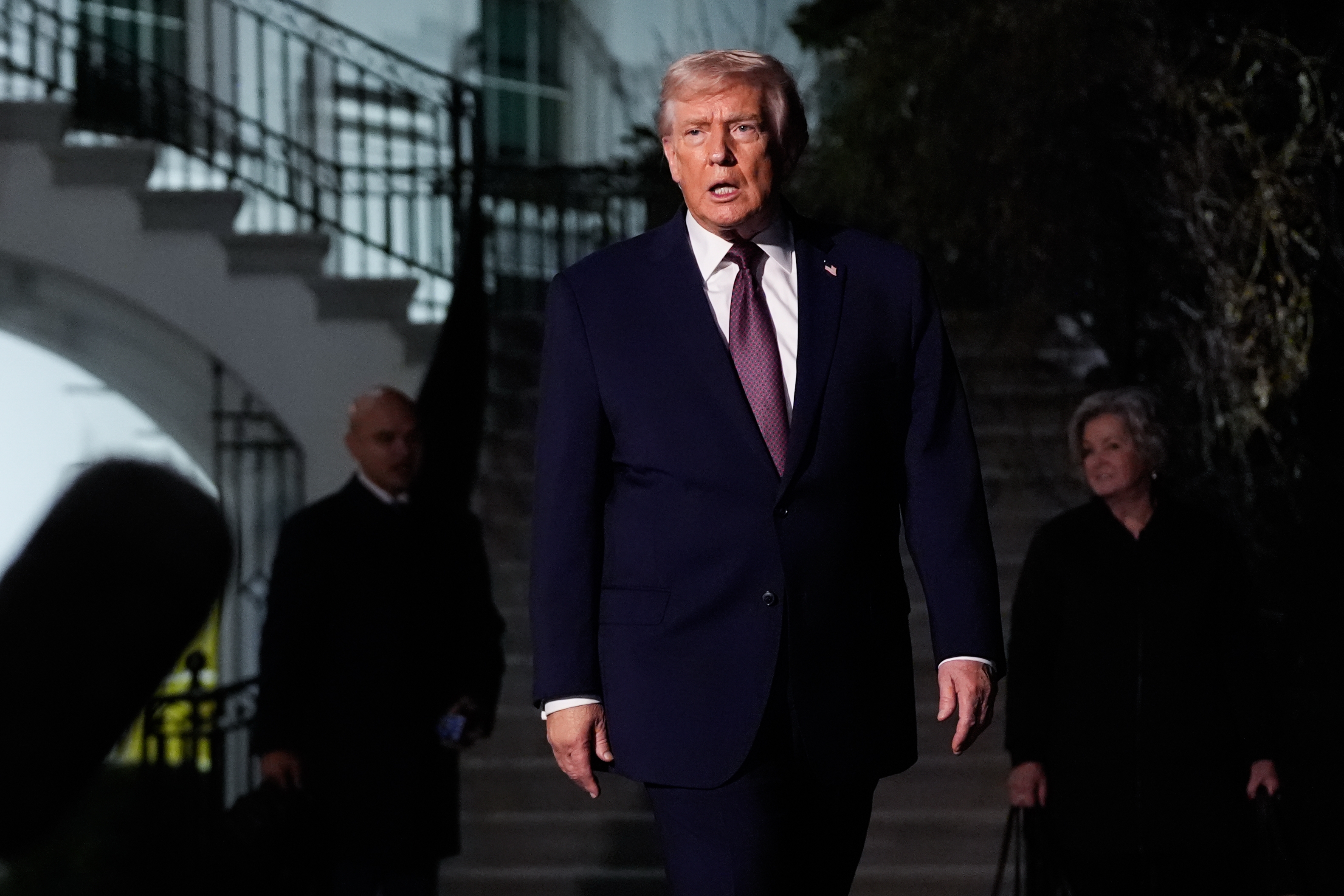 President Trump walks to speak with reporters while departing the White House  on Friday.