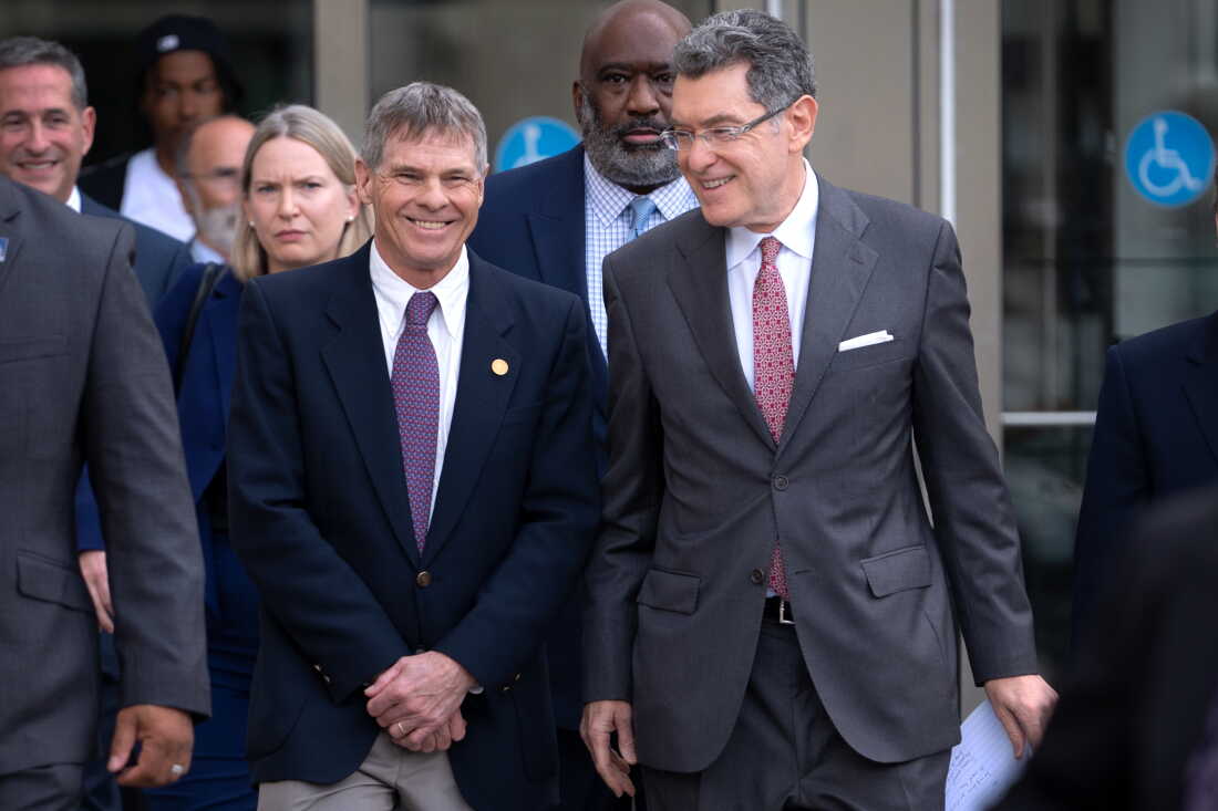 Former Olympic canoeist David Hearn, left, and his attorney Norm Eisen, right, leave D.C. court with a smile in early September after a hearing about the dismissal of his vandalism charges.