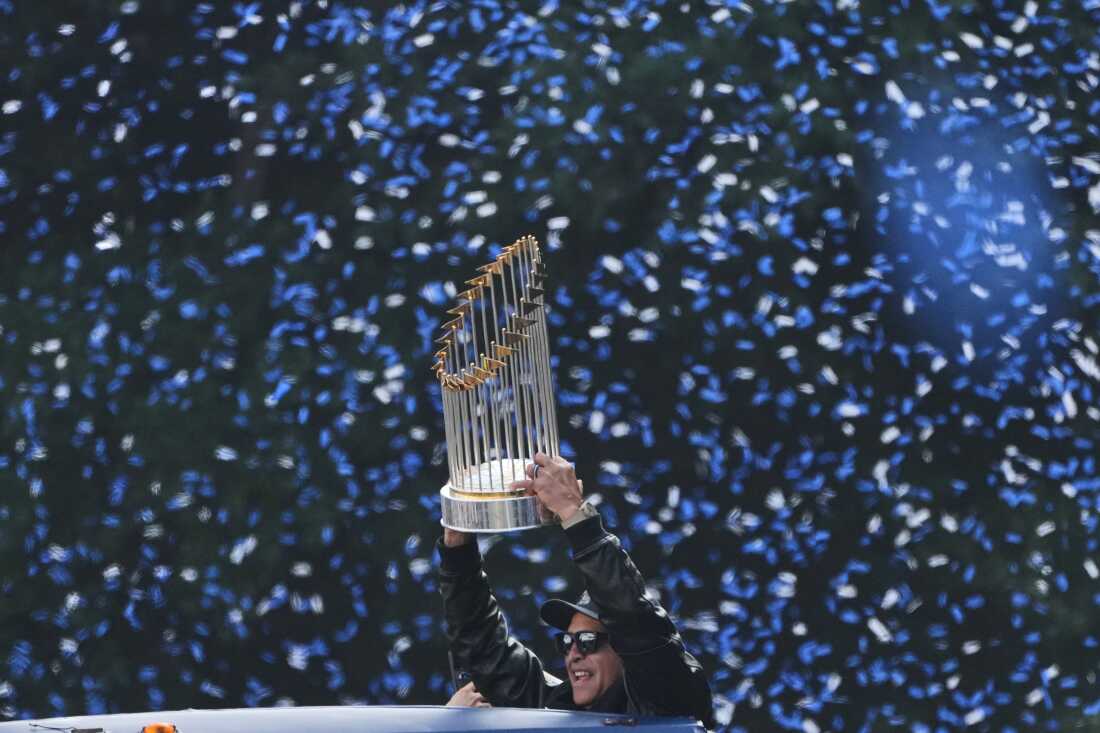 Los Angels Dodgers manager Dave Roberts holds the World Series trophy during a parade to celebrate the baseball team's World Series win on Monday, Nov. 3, 2025, in Los Angeles.
