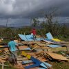 Residents stand on the wreckage of a house destroyed by Hurricane Melissa in Santa Cruz, Jamaica, Wednesday, Oct. 29, 2025.
