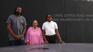 Alabama voters Evan Milligan (left), Sheyann Christburg-Webb and and Tyler Adams meet at the Civil Rights Memorial in Montgomery, Ala.