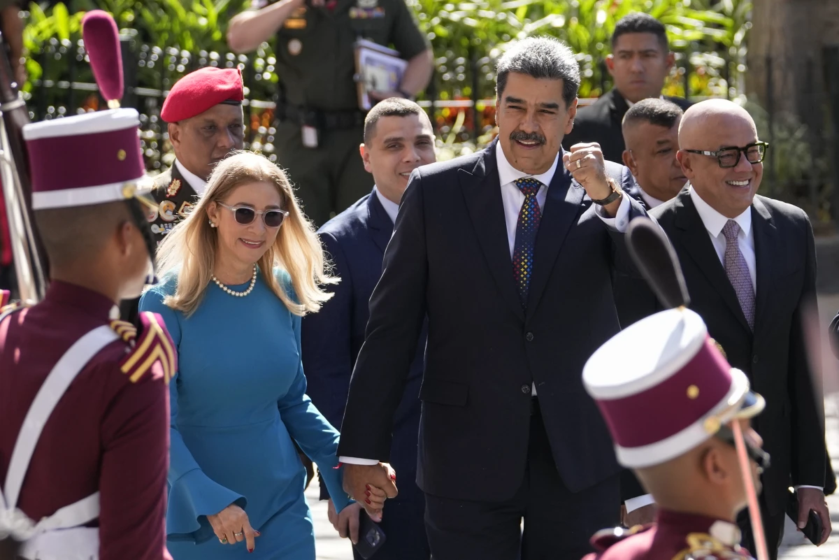 Venezuelan President Nicolas Maduro and his wife Cilia Flores arrive at the National Assembly for his swearing-in ceremony for a third term in Caracas, Venezuela, Friday, Jan. 10, 2025