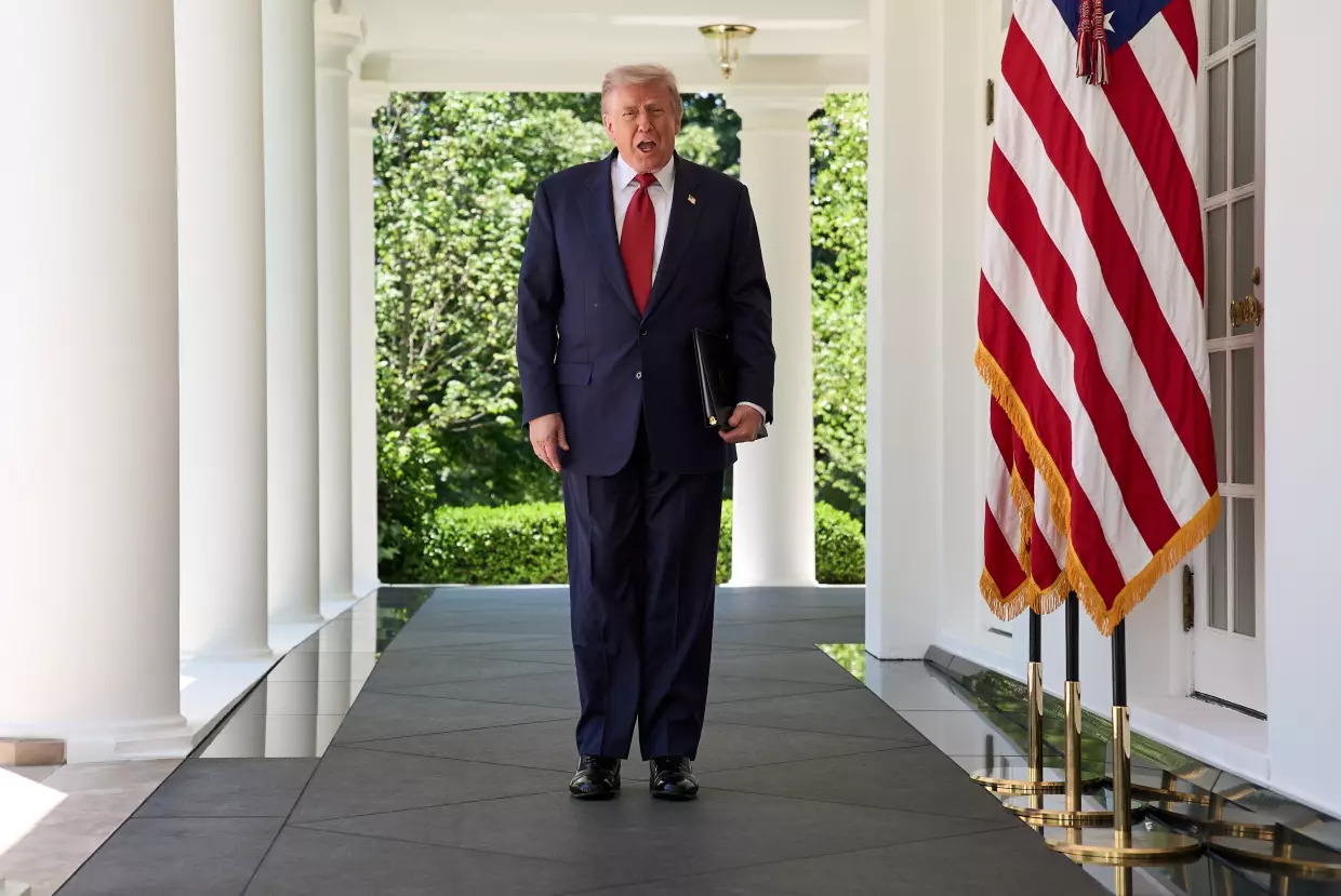 President Donald Trump walks through the Colonnade of the White House as he arrives to attend a luncheon for mothers Friday, May 8, 2026, in the Rose Garden of the White House, in Washington.