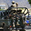 Yemen's Houthi armed forces patrol as Yemeni prisoners loyal to the Houthi authorities arrive in the capital Sanaa on Sep. 12, after being released on the west coast where he and others were being held by Yemen's Saudi-backed government forces.
