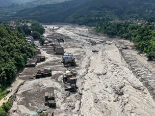 Houses lie partially submerged in muddy water along a riverside after flash floods at Trishuli Bazar in Nepal's Nuwakot district.