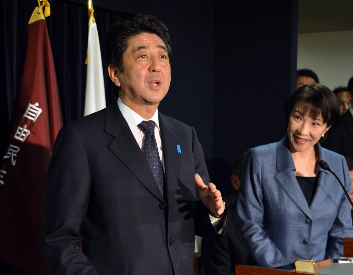 Takaichi looks on as incoming Prime Minister Shinzo Abe speaks to the media in Tokyo in 2012.