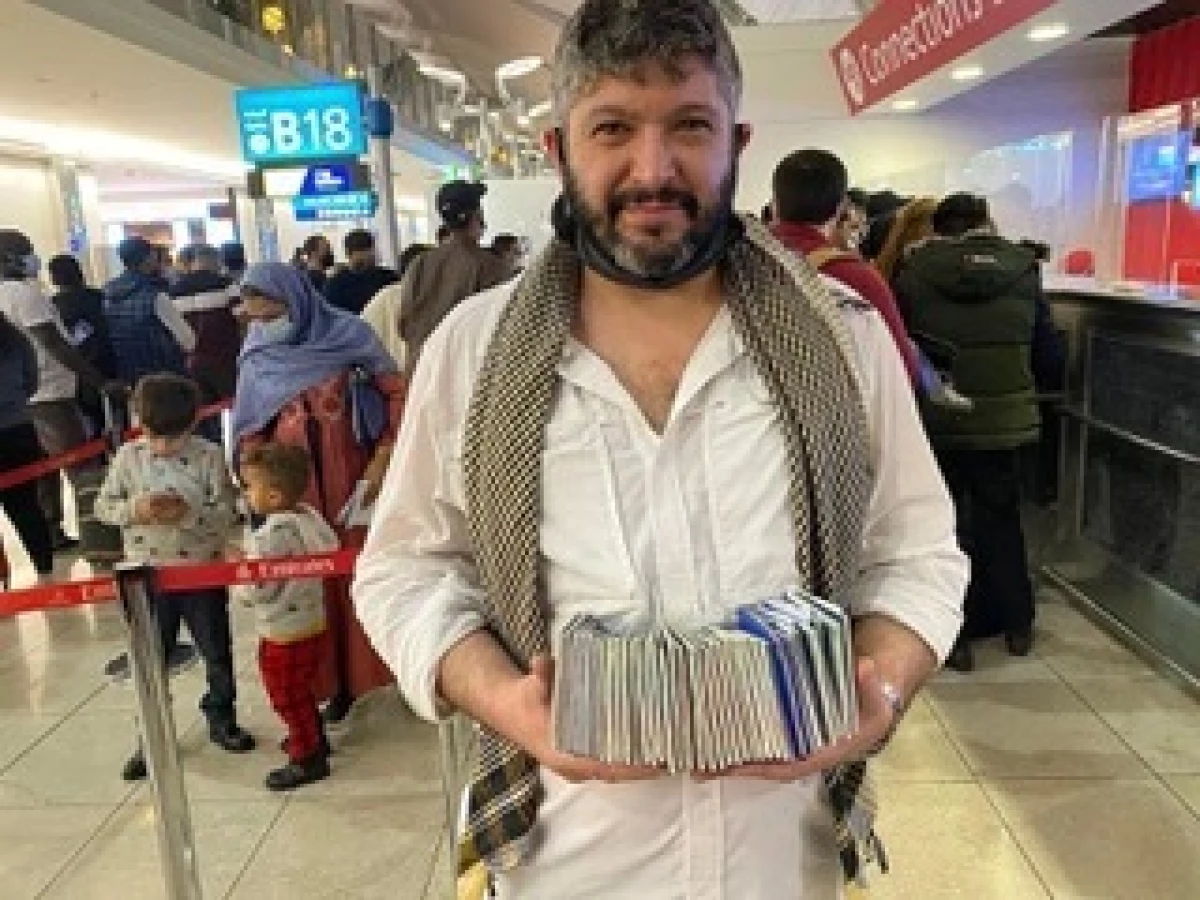 Army and Navy combat veteran Bryan Stern at Kabul airport holding passports for evacuees.