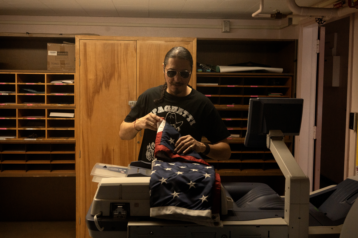 Guerrero folds an American flag at a school in LA where he works as a janitor on May 12, 2023.