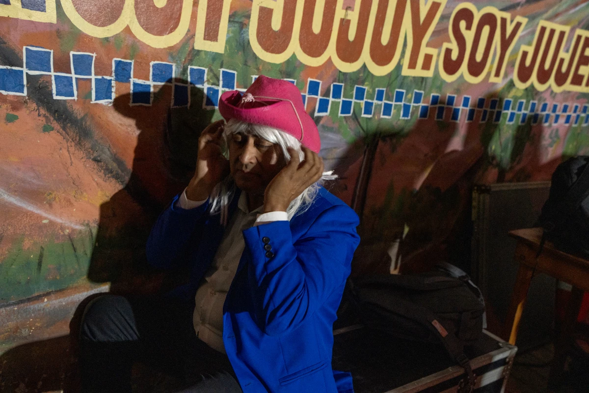 Martin Oropeza, the crowd entertainer for the band Sabor Karpero, gets ready for a performance at the Peña de Mario Ibarra in Buenos Aires' La Boca barrio on July 28, 2024.