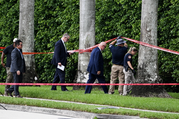 Law enforcement officials work at the crime scene outside the Trump International Golf Club in West Palm Beach, Fla. on September 16, 2024, the day after the attempted assassination of then-GOP presidential candidate Donald Trump.