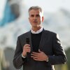 Disney CEO Josh D'Amaro, standing outdoors and holding a microphone, attends the press day of Disney Adventure World and World of Frozen at Disneyland Paris on March 28.