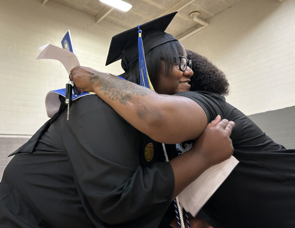 Janet Johnson, left, hugs her sister, Vanilla Murphy, at a graduation ceremony inside the prison gymnasium at the Maryland Correctional Institution for women.
