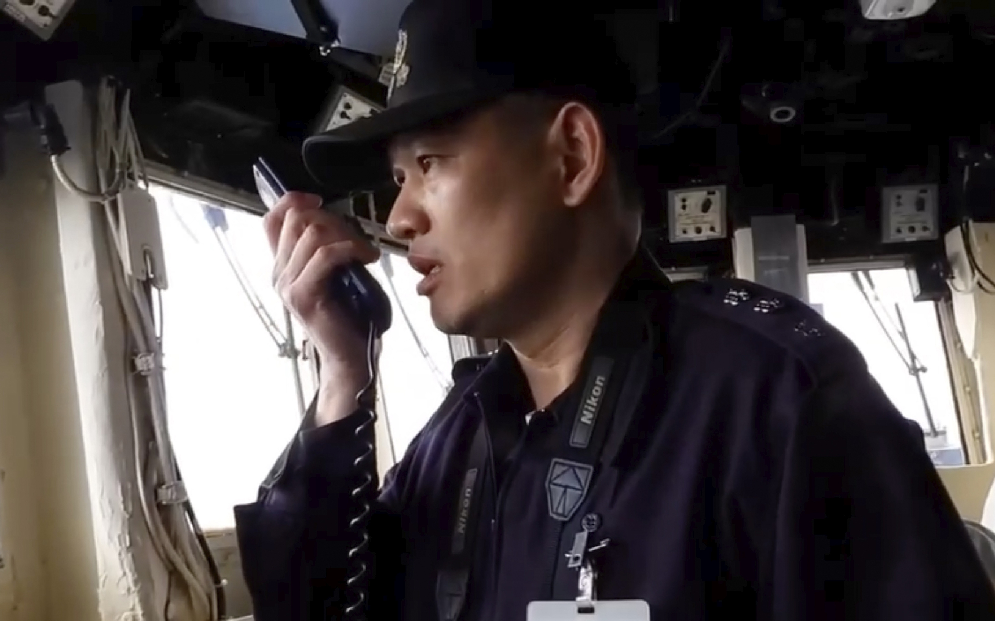 In this image taken off a video released by the Taiwan Ministry of National Defense, a member of Taiwan Navy reacts on the intercom to Chinese war ships conducting drills about 40 nautical miles off the coast of western Taiwan