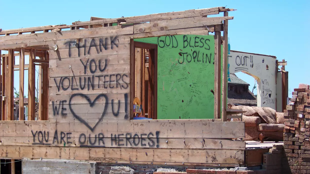 In the aftermath of the tornado,  thousands of volunteers came to help Joplin from around the country. Many wrote messages of hope on this tornado-damaged house, and later, Joplin residents wrote a thank-you message to the volunteers.