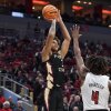 Florida State forward Cam Corhen (3), shoots over Louisville forward Roosevelt Wheeler (4) during the first half of an NCAA college basketball game in Louisville, Ky., Saturday, Feb. 4, 2023.
