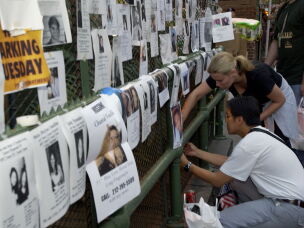 Friends and family members of people missing after the 9/11 terrorist attacks post signs with photos and descriptions outside the Lexington Avenue Armory in New York City on Sept. 13, 2001.