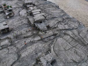 A drone view shows rescue workers inspect the area and damaged structures following recent flash flooding along the Trishuli River in the Devighat area of Nuwakot district, Nepal, Saturday, Aug. 29, 2026.