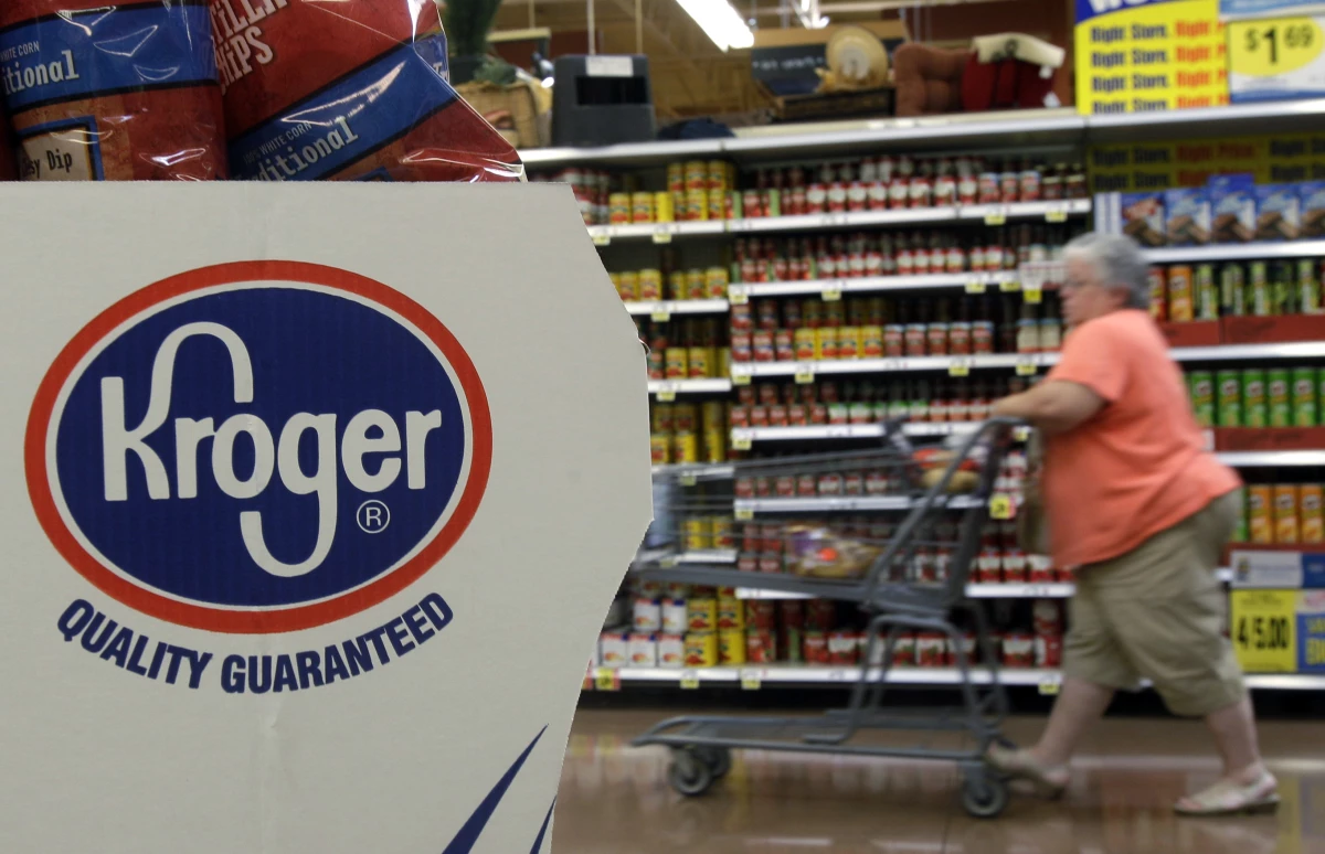 A shopper pushes a cart through a Kroger supermarket in Newport, Ky.