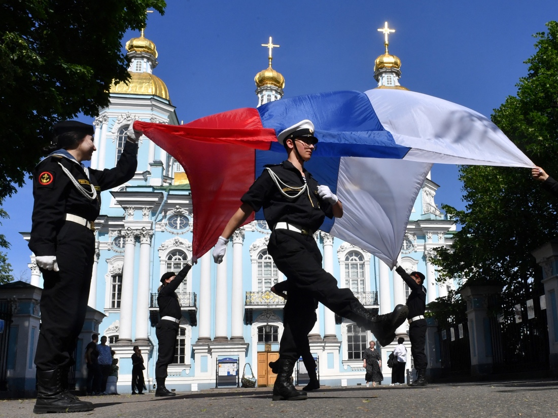 Russian navy recruits perform with the Russian flag in St. Petersburg, Russia, on June 4 during a ceremony marking the departure of recruits to join the army.